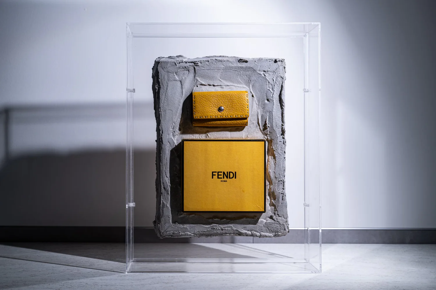 A preserved yellow artifact in an acrylic case